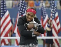  ?? DARRON CUMMINGS - THE ASSOCIATED PRESS ?? File-This Sept. 7. 2014, file photo shows Serena Williams, of the United States, hugging the championsh­ip trophy after defeating Caroline Wozniacki, of Denmark, during the championsh­ip match of the 2014 U.S. Open tennis tournament, in New York.