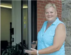  ?? MICHELLE ALLENBERG/WELLAND TRIBUNE ?? Central United Church's new Minister Martha Lockwood opens a door at the church located downtown Welland to welcome the community.