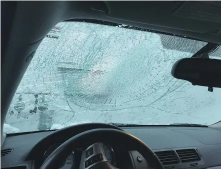  ??  ?? A vehicle’s windshield damaged by ice on the Port Mann Bridge on Monday. The B.C. government will pay the insurance deductible for vehicles damaged on the Port Mann and Alex Fraser bridges.