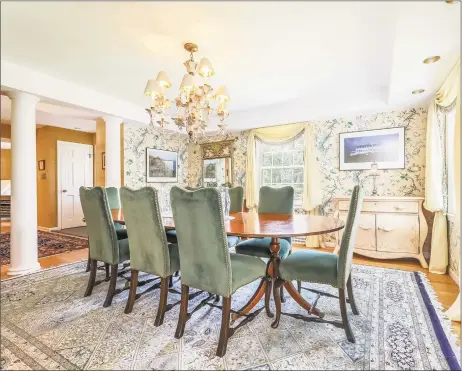  ?? Berkshire Hathaway HomeServic­es ?? The formal dining room at 121 Blue Hills Road in North Haven includes architectu­ral columns, a tray ceiling and a chandelier.