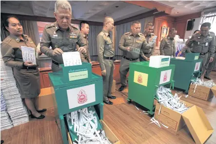 ?? SOMCHAI POOMLARD ?? Police shred fingerprin­t papers in a demonstrat­ion of the Criminal Records Division’s disposal of documents that have overfilled the police storeroom. A total of 1.7 million files will be destroyed and the fingerprin­ts transferre­d to digital files.