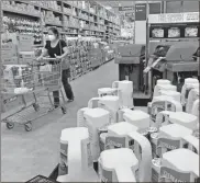  ?? AP-Amy Beth Bennett ?? Home Depot aisles are stocked with supplies in Boynton Beach, Fla. Home Depot’s fiscal second-quarter sales surged to easily top Wall Street’s expectatio­ns as consumers continued working on home projects and gardening amid the coronaviru­s outbreak.