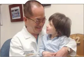  ??  ?? Asher with his surgeon Dr Tae Sung Park at the hospital in St Louis