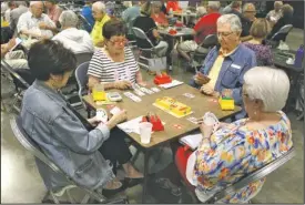  ?? The Sentinel-Record/Richard Rasmussen ?? DEAL THE CARDS: Joyce Franklin, left, of Little Rock, Shirley Haydel, of McComb, Miss., Art Pheifer, of Little Rock, and Dixie Miller, of Bogue Chitto, Miss., play bridge during the Resort City Regional bridge tournament Tuesday at Hot Springs...