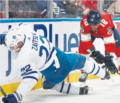  ?? JOEL AUERBACH GETTY IMAGES ?? Leafs defenceman Nikita Zaitsev gets a rough ride from Florida’s Micheal Haley during Toronto’s overtime loss.