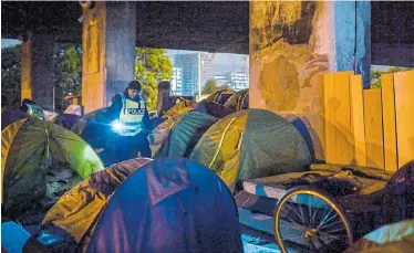  ?? Picture: MARTIN BUREAU/AFP ?? FORCED EVACUATION: Migrants are moved from a makeshift camp in Paris, France, by the police and Gendarmeri­e on Thursday. Hundreds of migrants and homeless people had settled in the area over the past few months