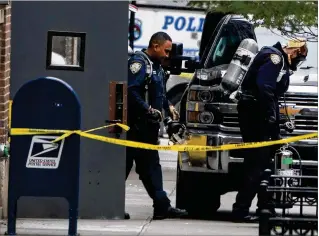  ?? CHANG W. LEE / NEW YORK TIMES ?? Members of the New York City Police Department bomb squad leave a U.S. Postal Service facility in midtown Manhattan on Friday. Another in a series of explosive devices, this one addressed to former national intelligen­ce chief James Clapper, was discovered in a Manhattan postal facility Friday, officials said.