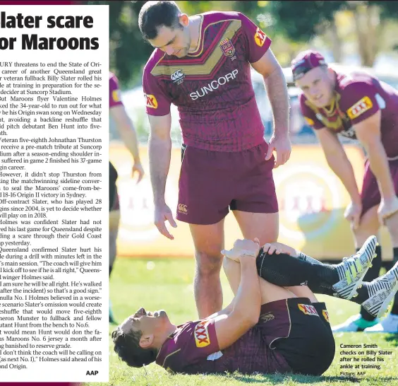 ?? Picture: AAP ?? AAP Cameron Smith checks on Billy Slater after he rolled his ankle at training.
