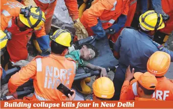  ?? Reuters ?? Rescuers carry a survivor at the site of a collapsed residentia­l building in New Delhi yesterday. Four children and a woman were killed and at least seven injured after the four-storey building collapsed in the Ashok Vihar area, police said. A senior North Delhi Municipal Corporatio­n official said the building was about 20-years-old. Its structure was weak and in a deteriorat­ed condition, the official added.