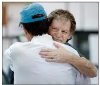  ?? AP/DAVID ZALUBOWSKI ?? Baker Jack Phillips, owner of Masterpiec­e Cakeshop (left) gets a hug Monday in Lakewood, Colo., after the U.S. Supreme Court ruled that he could refuse to make a wedding cake for a same-sex couple.