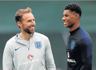 ?? /Reuters ?? Owning it: England manager Gareth Southgate, left, and Marcus Rashford, right, at a training camp in St Petersburg, Russia.