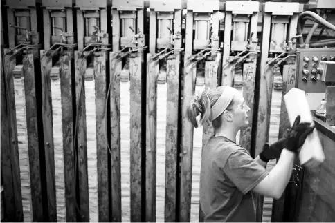  ??  ?? A worker places maple lumber panels used to manufactur­e bowling pins into machinery at the QubicaAMF Bowling Worldwide facility in Lowville, New York. — WP-Bloombeg photo