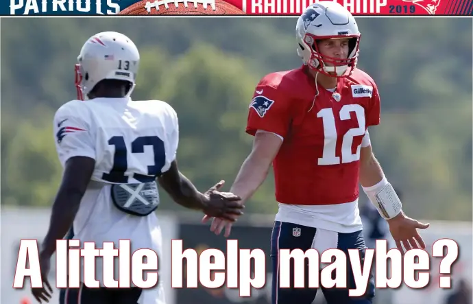  ?? NANCY LANE / BOSTON HERALD ?? HUH? Quarterbac­k Tom Brady appears to be looking for answers as receiver Phillip Dorsett walks by during yesterday’s training camp workout in Foxboro.