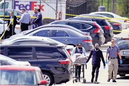  ??  ?? Officers and other personnel work the scene Friday where multiple people were shot at a FedEx Ground facility in Indianapol­is the day before. A gunman killed eight people before taking his own life. MICHAEL CONROY/AP