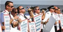  ?? TNS ?? Southwest Airlines pilots picketing for better work conditions on Tuesday outside Dallas Love Field. The largest pilots union has approved a contract that would boost the pay of pilots at United.