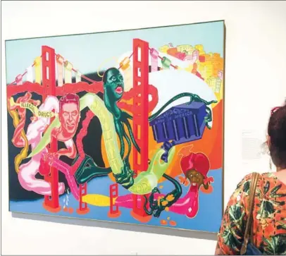  ?? THOMAS URBAIN/AFP ?? A patron looks at Government of California(1969) by Peter Saul during an exhibition at the Met Breuer, Metropolit­an Museum of Art titled ‘Everything is Connected: Art and Conspiracy’ on Monday in New York.