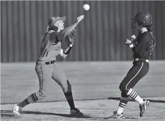  ?? STAFF PHOTO BY DOUG STRICKLAND ?? Lakeview-Fort Oglethorpe shortstop Taylor Phillips throws to first base to try for the double play after forcing out Calhoun’s M.J. Mashburn at second during Wednesday’s Region 6-3A championsh­ip series in Fort Oglethorpe. Calhoun swept the doublehead­er...