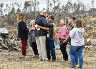  ?? NICHOLAS KAMM / AFP / GETTY IMAGES ?? President Donald Trump greets residents Friday on a tour of tornado-hit areas in Beauregard, Alabama. Trump said he told FEMA to give Alabama “the A Plus treatment” as it recovers. Sunday’s tornado was the deadliest in the U.S. since May 2013, when 24 were killed in Moore, Oklahoma.