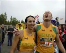  ?? DAVID KEYTON - THE ASSOCIATED PRESS ?? Lithuanian couple Vytautas Kirkliausk­as, right, and Neringa Kirkliausk­iene celebrate their victory in the wife carrying race, a 278-yard obstacle course, during the 24th world championsh­ips in Sonkajarvi, Finland, Saturday. Despite the event’s name couples don’t have to be married, and organizers say male contestant­s could “steal a neighbor’s wife” if they didn’t have a female companion.