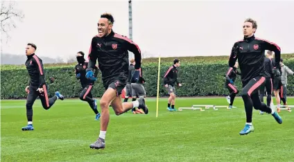  ??  ?? Up and running: Pierre-emerick Aubameyang (centre) and Nacho Monreal lead the way in yesterday’s Arsenal training