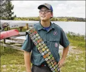  ?? LUIS SANTANA / TAMPA BAY TIMES ?? Ron Cain, 18, wears a special sash that displays all 137 of his badges. In September, he joined the company of about 350 boys who have achieved the milestone in the Boy Scouts’ 107-year history.