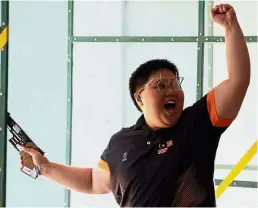  ??  ?? Golden finish: Alia Sazana Azahari celebratin­g her victory in the 25m pistol final during the KL SEA Games at the Subang Shooting Range last month.