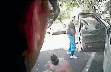  ?? PHOTOS: REUTERS ?? An image from video released by Charlotte police shows Keith Scott looking at police officers with hands by his sides just before he was shot four times by them.