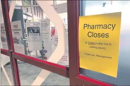  ?? TOM MURPHY — THE ASSOCIATED PRESS ?? A sign is posted outside a CVS pharmacy on Thursday in Indianapol­is. A rush of vaccinesee­king customers and staff shortages are squeezing drugstores around the country.