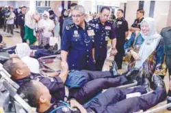  ??  ?? Mohamad Fuzi speaking to police personnel during the blood donation drive in Bukit Aman yesterday.