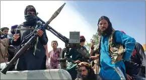  ?? Photo: Nampa/AFP ?? Threats… Taliban fighters sit over a vehicle on a street in Laghman province on Sunday.