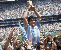  ?? ?? Diego Maradona holds up the trophy after the World Cup final in 1986