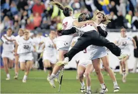  ?? ELISE AMENDOLA/ASSOCIATED PRESS ?? Boston College goalkeeper Lauren Daly (34) jumps to hug teammates Brooke Troy (28) and Carly Bell, right, after the Eagles defeated Navy 16-15 in Friday’s semifinals.