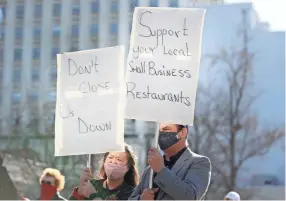  ?? JOE RONDONE/THE COMMERCIAL APPEAL ?? Anita Chu and Joe Torres, owners of Ani Joe’s Baila restaurant, join a gathering to protest the looming threat of closures from a new Safer at Home directive downtown on Monday.