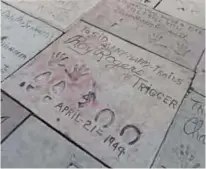  ??  ?? Roy Rogers added the hoof prints of his horse Trigger as well as an imprint of his revolver to the cement at his Hand and Foot print ceremony in 1949 in front of the TCL Chinese Theater.