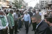  ?? MOHAMMED MOHAMMED/AP ?? Top Hamas leader in Gaza, Yehiyeh Sinwar (center), pays his respects at a house of mourning for a Hamas commander killed earlier this month in the group’s war with Israel.