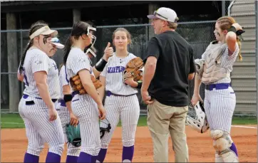  ?? PHOTOS BY JENNIFER ELLIS/STAFF PHOTOGRAPH­ER ?? The Lady Eagles infield huddles in the circle as junior pitcher Kylee Branscum gives coach Jeff Hill the thumbs up in a 3-10 loss at Conway on Feb. 27.