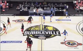  ?? Jessica Hill / Associated Press ?? Louisville and DePaul players warm up before an NCAA college basketball game in Mohegan Sun’s Bubblevill­e in Uncasville on Dec. 4.