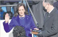 ?? Saul Loeb The Associated Press ?? Kamala Harris is sworn in as vice president by Supreme Court Justice Sonia Sotomayor as Harris’ husband, Doug Emhoff, holds the Bible.