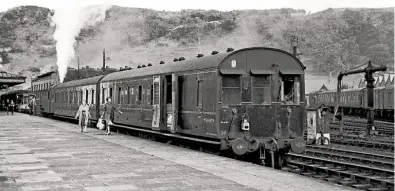  ?? JOHN PRICE ?? A large number of two-carriage trailers were produced by the LMS/BR(LM) for push-pull working. This involved building a driving compartmen­t into the brake of a standard 57ft non-corridor coach. Here, the 3.50pm to Amlwch, comprising such a set, stands in Bangor station on August 21, 1964, with Ivatt ‘2MT’ No. 41226 at the rear. Note the distinctiv­e metal shades above all three windows of trailer No. M24437M, also the white letters ‘Pl & Ps’, standing for ‘Pull-Push’ below the nearside window. The set was among the last to be built at Wolverton, in 1949.