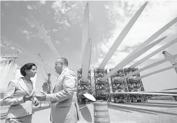  ?? Steven Senne photos / Associated Press file ?? Rhode Island Gov. Gina Raimondo speaks with Deepwater Wind CEO Jeffery Grybowski last month while touring a staging site at the Port of Providence in Rhode Island.