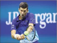  ?? Matthew Stockman / Getty Images ?? Novak Djokovic returns the ball against Alexander Zverev during the U.S. Open semifinals on Friday.