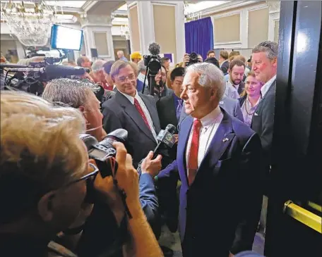  ?? Allen J. Schaben Los Angeles Times ?? JOHN COX, shown speaking to media after the June primary, has made his tale of self-made success a central theme of his campaign for California governor. The Republican businessma­n from Rancho Santa Fe lists himself as president or a shareholde­r in 15 separate firms.