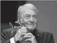  ?? GERO BRELOER/AP PHOTO ?? In this Feb. 14, 2013 file photo, French film director Claude Lanzmann holds the Honorary Golden Bear at the 63rd edition of the Berlinale, Internatio­nal Film Festival in Berlin, Germany. Lanzmann, director of the epic movie “Shoah,” has died at age 92...