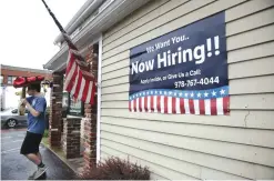  ?? —AP ?? MIDDLETON: In this July 24, 2017, file photo, a sign advertisin­g employment hangs outside a restaurant in Middleton, Massachuse­tts. US businesses added a solid 178,000 jobs in July, a survey found, evidence that employers remain confident enough about...