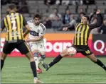  ?? The Canadian Press ?? Vancouver Whitecaps FC’s Brian White (middle) fires a shot for a goal during second half of CONCACAF Champions League soccer.