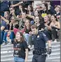  ?? AP/J. SCOTT APPLEWHITE ?? A police officer detains one of the activists who rushed past barriers to protest from the steps of the Capitol on Saturday before Brett Kavanaugh’s confirmati­on vote.