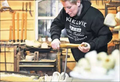  ?? MAUDE BRULARD / AGENCE FRANCE-PRESSE ?? Shoemaker and former soldier Nicole van Aarle bores a hole out of a wooden shoe in Aarle-Rixtel, in the southern Netherland­s.