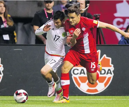  ?? RICH LAM/GETTY IMAGES FILES ?? Mexico’s Hirving Lozano, left, and Canada’s Adam Straith chase the ball during World Cup qualifying action at B.C. Place in 2016. B.C. Place could host up to five games if a unified bid featuring Canada, the United States and Mexico wins the right to host the 2026 tournament.