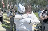  ?? RANDY VAZQUEZ — STAFF PHOTOGRAPH­ER ?? Cheryl Walsh, front, hugs Donna Zolezzi, back, after the laying of a wreath during a Memorial Day observance at Oak Hill Memorial Park in San Jose.