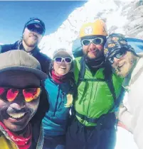  ?? PHOTO: SUPPLIED ?? High camp . . . Sam Henehan (second right) and his travel buddies enjoy some rare sunshine at high camp.